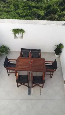 a wooden table and chairs on a patio at Marietta's House in Rhodes Town