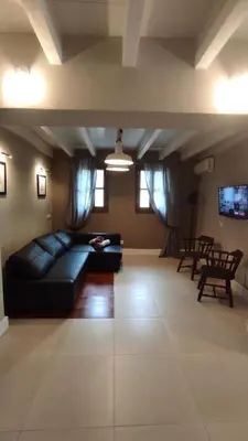 a living room with a black couch and chairs at Marietta's House in Rhodes Town