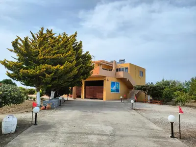 a house with a tree in front of it at Garden View Appartment (Thanasis) in Kalavárda
