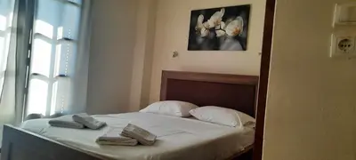 a bedroom with a bed with towels on it at Villa Bianca in Kremasti