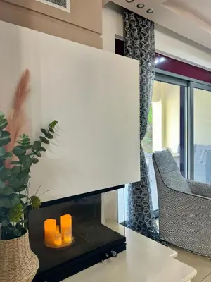a living room with a fireplace with orange candles at Villa Chrysa Rhodes with Heated Pool in Afantou