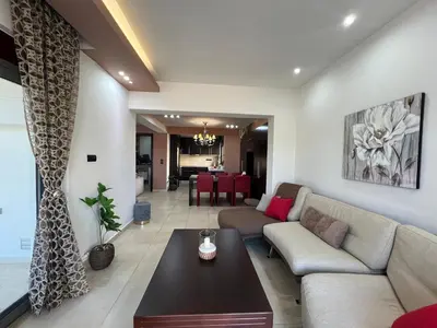 a living room with a couch and a table at Villa Chrysa Rhodes with Heated Pool in Afantou