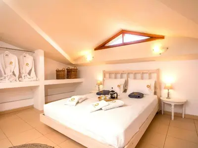 a bedroom with a bed with towels on it at Holiday Home near Beach in Afandou in Koskinou