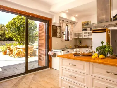 a kitchen with an open door to a patio at Holiday Home near Beach in Afandou in Koskinou