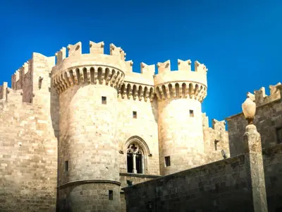a large castle with a tower and a wall at Holiday Home near Beach in Afandou in Koskinou