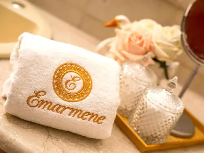 a towel on a tray next to a vase of flowers at Holiday Home near Beach in Afandou in Koskinou