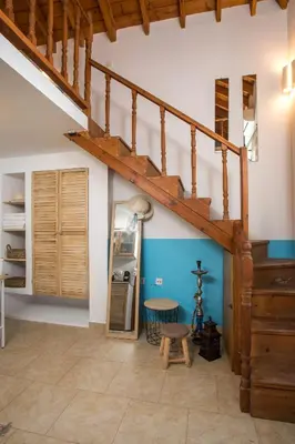 a living room with a staircase and a table at Annas Houses in Halki