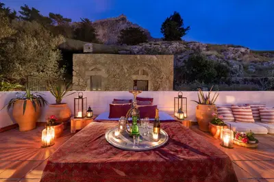 a patio with a table with lights on it at Acropolis Lindos House in Líndos