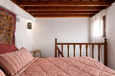 a bedroom with a bed and a wooden ceiling at Acropolis Lindos House in Líndos