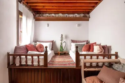 a living room with two beds and a window at Acropolis Lindos House in Líndos