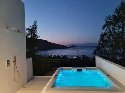 a swimming pool on the balcony of a house at Tilos Villa in Livadia