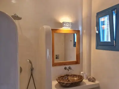 a bathroom with a sink and a mirror at Tilos Villa in Livadia