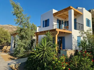 a villa with a view of the house at Tilos Villa in Livadia
