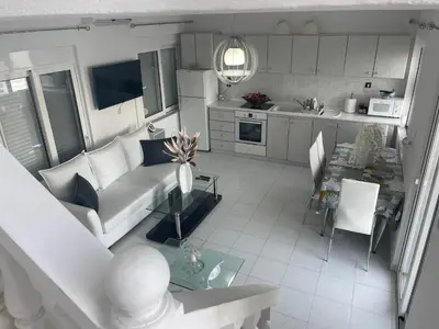 a living room with a couch and a table at VILLA BLANCA in Haraki
