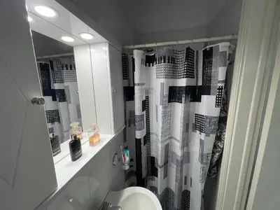 a bathroom with a black and white shower curtain at VILLA BLANCA in Haraki