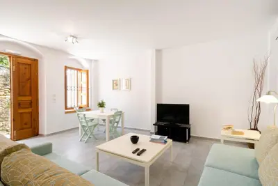 a living room with a couch and a table at Villa Sokaki in Líndos