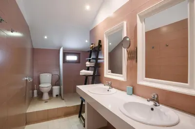 a bathroom with two sinks and a toilet at Villa Sokaki in Líndos