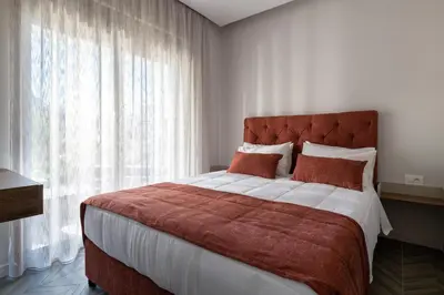 a bedroom with a large bed with a large window at ANIMA DEL SOL (BASILICO) in Ixia