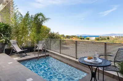a small pool on a balcony with a table and chairs at ANIMA DEL SOL (BASILICO) in Ixia
