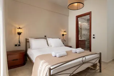 a bedroom with a bed with two towels on it at Casa di Vasia in Gennadi