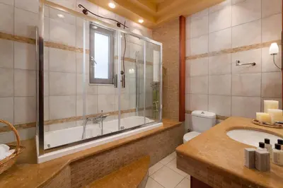 a bathroom with a tub and a toilet and a sink at Casa di Vasia in Gennadi
