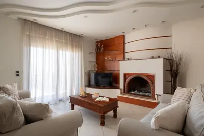 a living room with a couch and a fireplace at Casa di Vasia in Gennadi