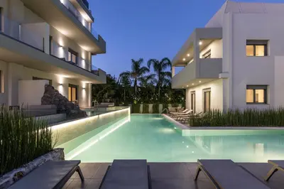 a swimming pool in front of a house at Sun City Luxury Apartments in Rhodes Town