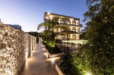 a building with a wooden walkway in front of a building at Sun City Luxury Apartments in Rhodes Town