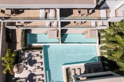 an overhead view of two swimming pools at a resort at Sun City Luxury Apartments in Rhodes Town