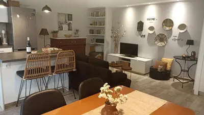 a living room with a couch and a table at Charming garden apartment in Rhodes Town