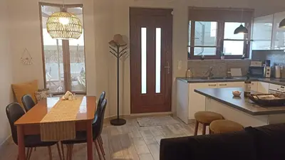 a kitchen with a table and a dining room at Charming garden apartment in Rhodes Town