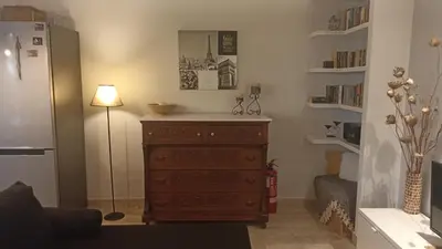a living room with a dresser and a lamp at Charming garden apartment in Rhodes Town