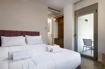 a white bed with two pillows on top of it at ANIMA DEL SOL ( LEVANTA ) in Ixia