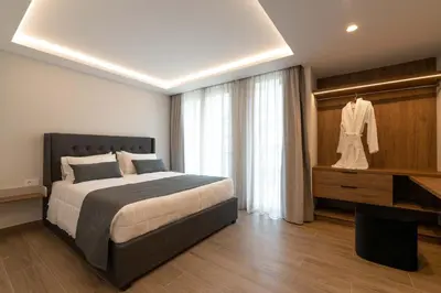 a bedroom with a bed and a dress on a rack at ANIMA DEL SOL ( LEVANTA ) in Ixia