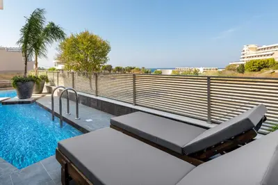 a balcony with a swimming pool and a benchitures at ANIMA DEL SOL ( LEVANTA ) in Ixia
