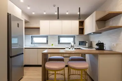 a kitchen with a large island with stools at ANIMA DEL SOL ( LEVANTA ) in Ixia