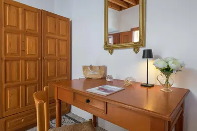 a room with a wooden desk with a mirror at Evangelia's Traditional Villa Lindos in Líndos