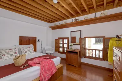 a bedroom with a bed and a wooden ceiling at Evangelia's Traditional Villa Lindos in Líndos