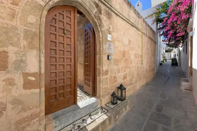 an entrance to a building with a wooden door at Evangelia's Traditional Villa Lindos in Líndos