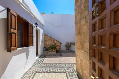 an alley in a house with a door at Evangelia's Traditional Villa Lindos in Líndos