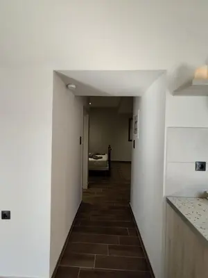 a hallway leading to a room with a bed at Althea Apartments 3 in Halki