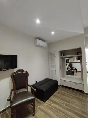 a living room with a couch and a chair at Althea Apartments 3 in Halki