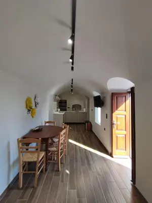 a dining room and kitchen with a table and chairs at Althea Apartments 3 in Halki