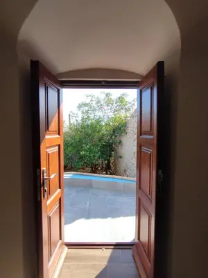 an open door with a view of a swimming pool at Althea Apartments 3 in Halki