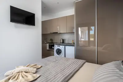 a kitchen with a bed with a towel on it at Penélope Beachfront Villa in Kremasti