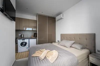 a bedroom with a bed with two towels on it at Penélope Beachfront Villa in Kremasti