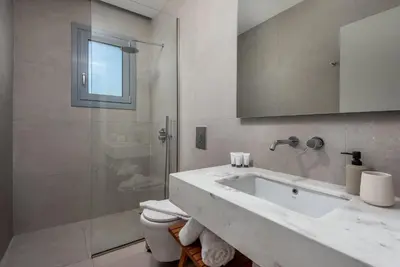 a bathroom with a toilet and a sink and a shower at Villa Heather in Kolimbia