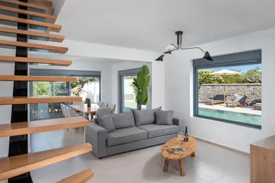 a living room with a couch and a table at Villa Heather in Kolimbia
