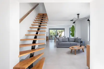 a staircase in the living room of a house at Villa Heather in Kolimbia