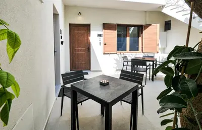 a table and chairs on a patio with plants at Borgo Nuovo in Rhodes Town